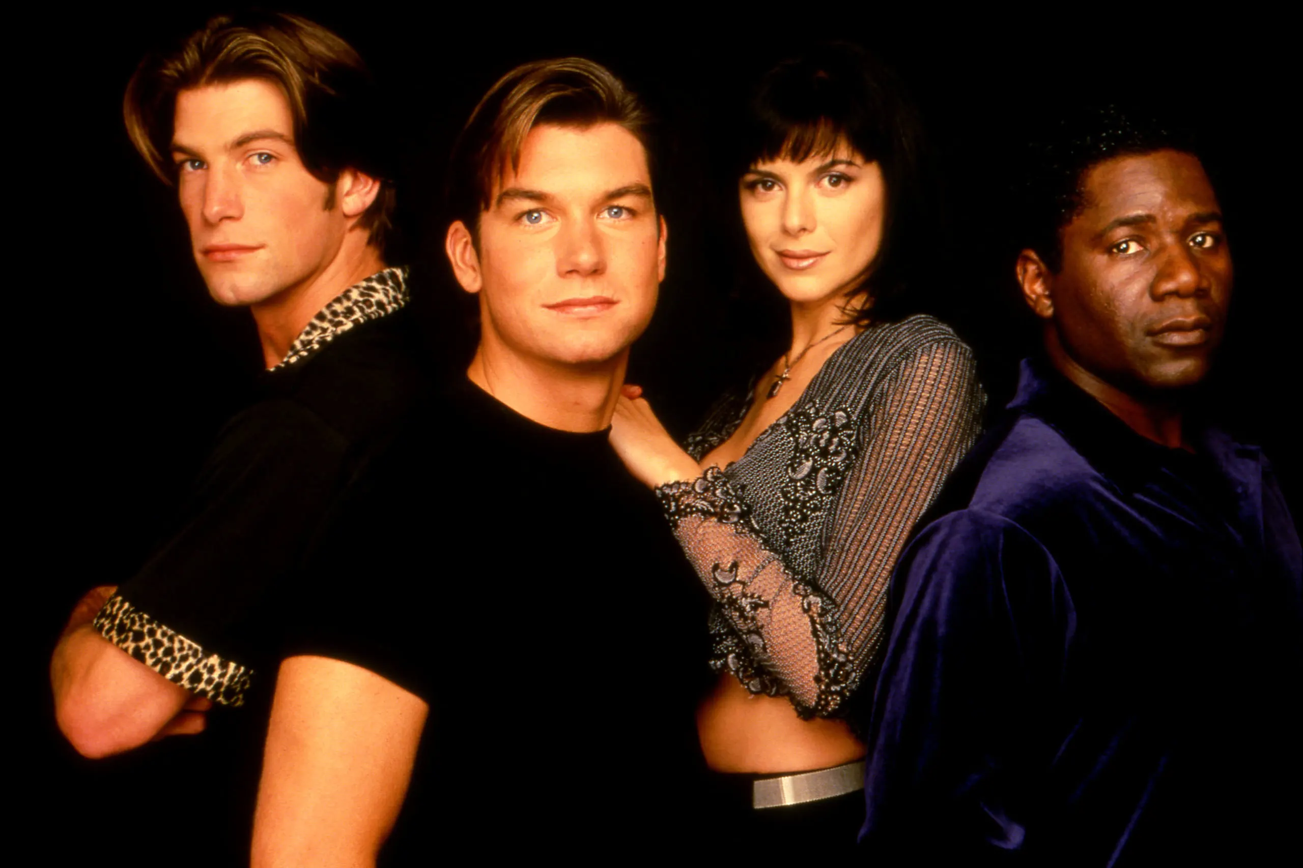 Promo photo of the Sliders cast from season four in front of a dark background