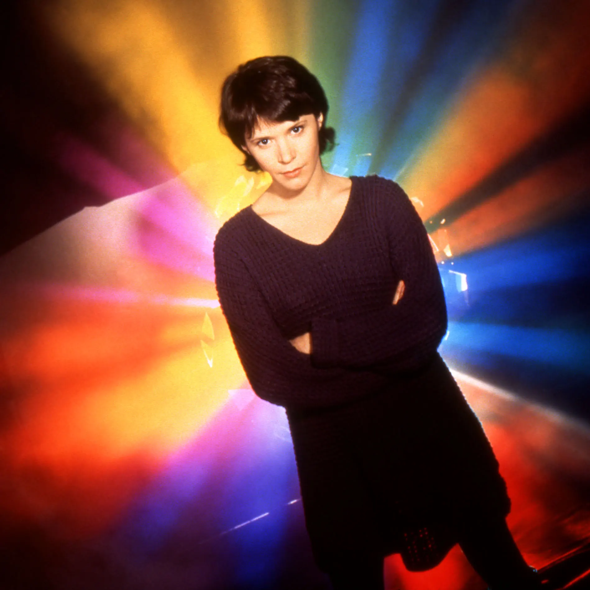 Sabrina Lloyd (Wade Welles) standing in front of a prism color background