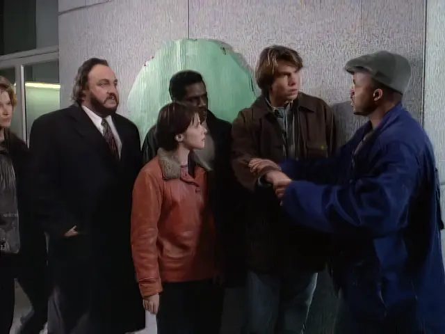 The Sliders talk to LJ on a street corner in San Francisco about buddy bracelets in the episode El Sid
