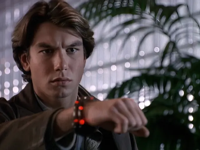 Quinn (Jerry O'Connell) looks at his buddy bracelet lighting up on his wrist