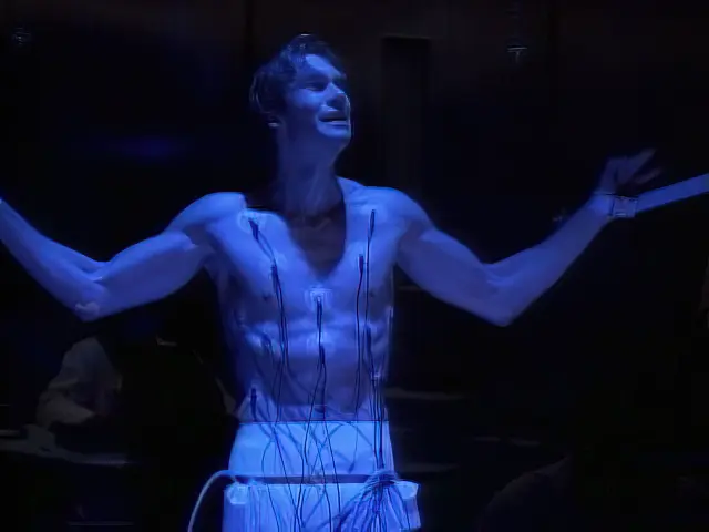 Quinn Mallory (Jerry O'Connell) being disinfected in a blue light room in the Sliders episode Fever