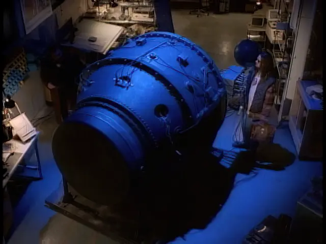 Conrad Bennish (Jason Gaffney) looks at the atomic bomb nicknamed Fat Man illuminated in blue light
