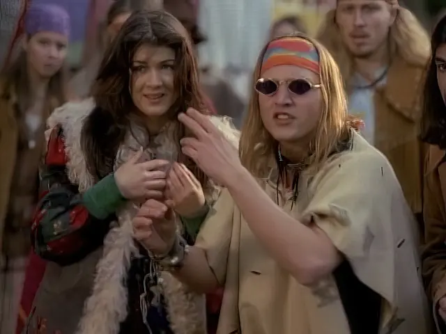 Hippie making a hand gesture to communicate with the Sliders in the episode Summer of Love