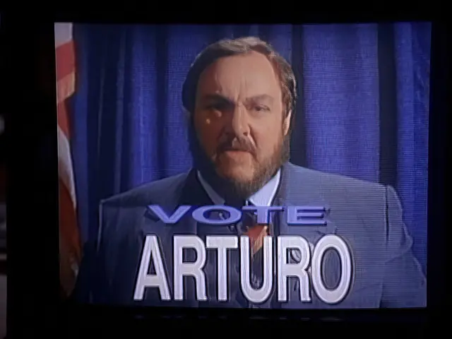 Professor Arturo (John Rhys-Davies) in a political campaign TV ad in the Sliders episode The Weaker Sex
